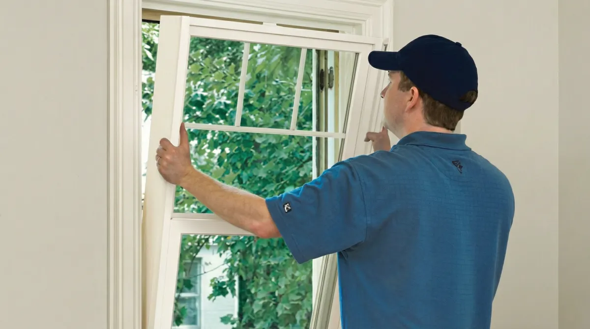 Professional contractors performing a residential window insulation and replacement service in Green Bay, WI